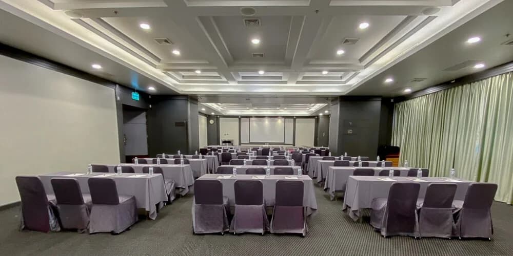 Round banquet tables in a supplied indoor hotel event-room photograph